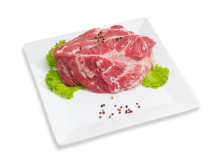 Piece of a fresh uncooked pork neck on square dish