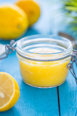 Lemon Curd in Jar on Blue Wooden Background