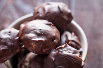 Homemade Healthy Paleo Raw Chocolate Truffles with Nuts, Dates and Marzipan on Dark Background