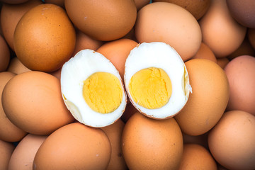 Boiled chicken egg placed on raw eggs.