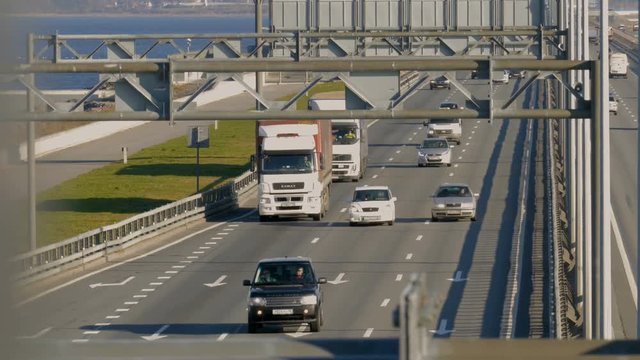 several trucks and cars driving on the highway. Saint-Petersburg, Russia, 2016
