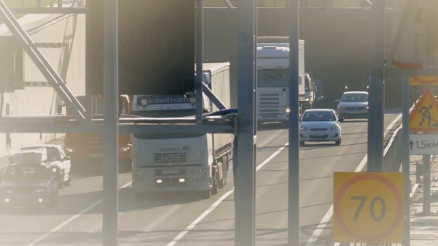 several trucks and cars driving on the highway. Saint-Petersburg, Russia, 2016