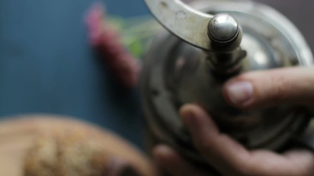 Grinds coffee beans in the old coffee grinder. Macro