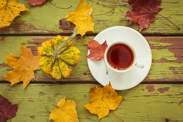 Decorative gourd and tea on a dark wooden table