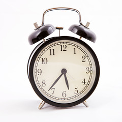 Black old style alarm clock with clipping path
