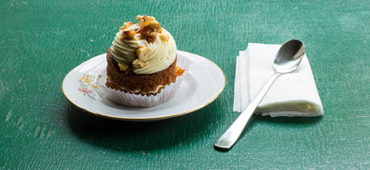 carrot cake with walnuts, prunes and dried apricots on a green wood background. tinting. selective focus