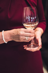 Woman holding a glass of white wine