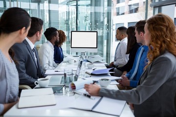 Business people looking at a screen during a video conference