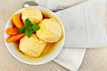 Ice cream apricot in white bowl on table top