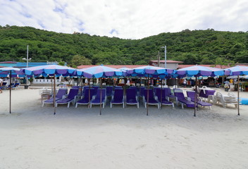 Front view of chairs and umbrella on the beach