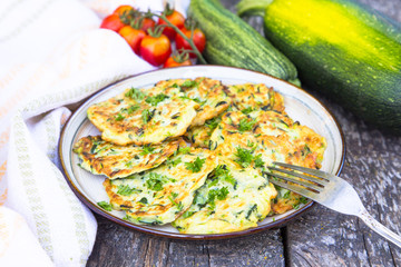 Squash and zucchini fritters on old wooden table