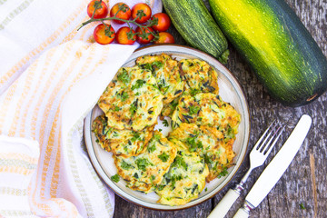 Squash and zucchini fritters on old wooden table