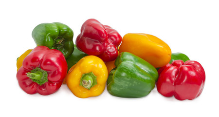 Yellow, red and green bell peppers on a light background