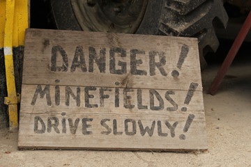 Danger!Minefields!Drive slowly! / The notice about minefields.