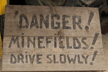 Danger!Minefields!Drive slowly! / The notice about minefields.