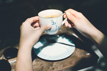 Fototapeta na wymiar Female hands holding cup of coffee.