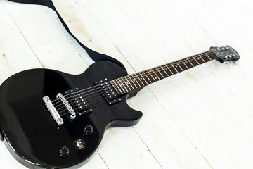 Naklejka na ściany i meble Electric guitar on old wooden surface