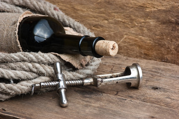 Obraz na płótnie Canvas Old corkscrew and bottle of wine