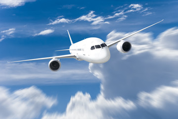 Naklejka na ściany i meble Podróż samolotem, samolot latający w błękitne niebo nad chmurami