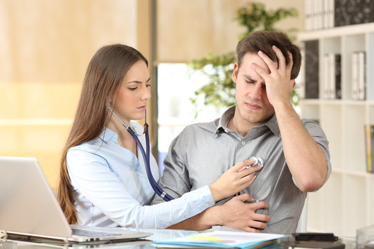 Doctor Examining A Patient At Office