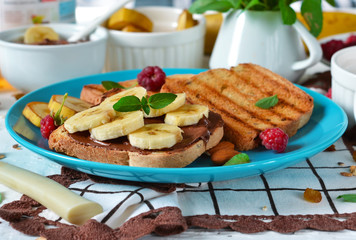 Good morning - toast with walnut, chocolate paste, banana and honey. White food background. 
