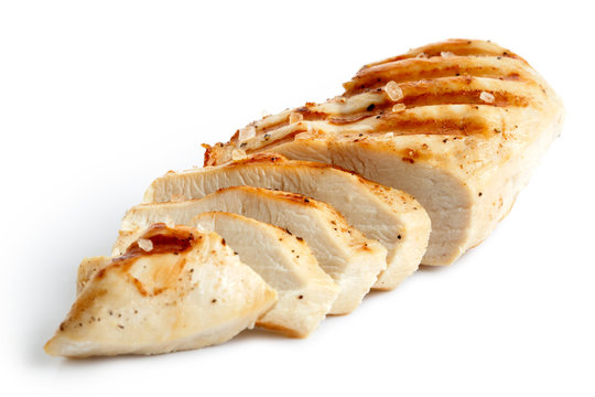  Partially sliced grilled chicken breast with black pepper and rock salt.