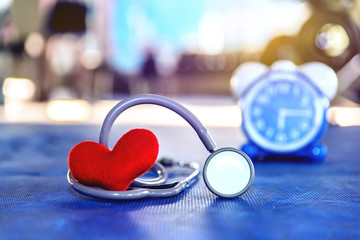 Red heart and Stethoscope on rubber in gym Take care of yourself to take time for exercise Concept