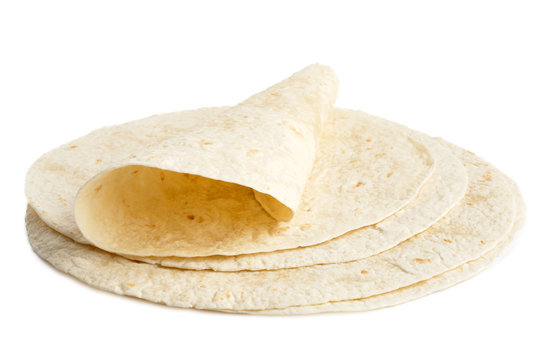 Stack of tortilla wraps and one folded wrap isolated on white.