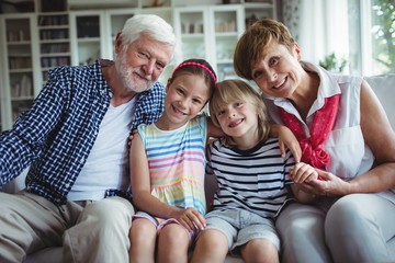 Portrait of grandparents sitting with their grandchildren