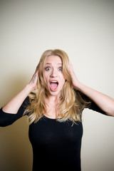 Stunned young woman on white portrait