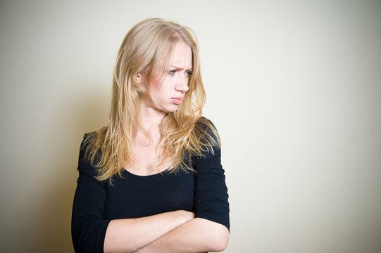 Young blonde woman angry and sullen portrait