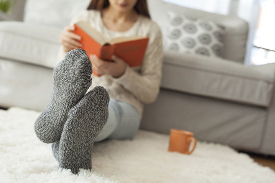 Young woman reading book in home