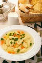 Soup with dumplings on white background.