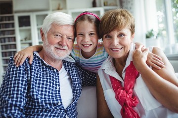 Grandparents with her grand daughter at home - obrazy, fototapety, plakaty