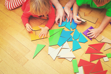 kids learning -little boy and girl playing with geometric shapes