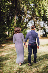 Happy pregnant woman and her husband in the park