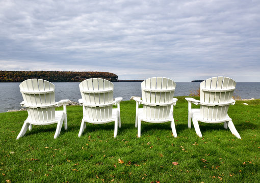 Lawn Chairs In A Row On The Beach In Autumn