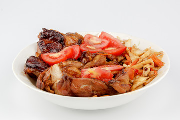 tomatoes and Chicken legs on white plate
