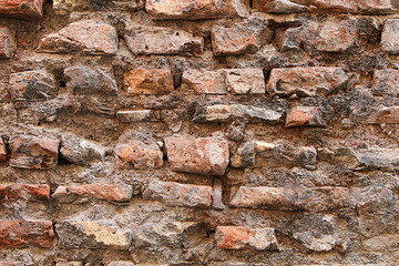 Wall of very old crumbling bricks