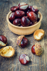 Fresh chestnuts on the old wooden table