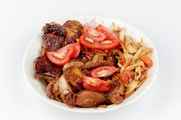 tomatoes and Chicken legs on white plate