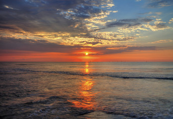 Fototapeta premium Beautiful sunrise over the sea with dramatic clouds on the sky