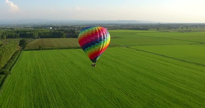 Aerial image of a hot air balloon that travels free in the sky full of colors in the green of nature. concept of life, liberty and happiness and travel.