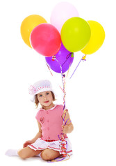 Fototapeta na wymiar Girl holding balloons