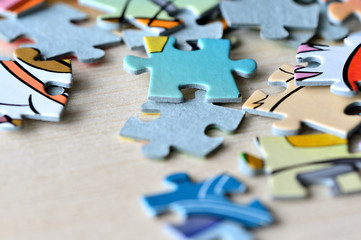 Children's puzzles on a wooden background close up