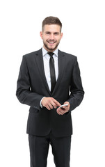Handsome businessman in suit using the phone in office