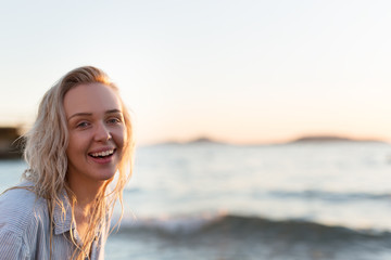 Happy carefree woman dancing at sunset on the beach. Happy free