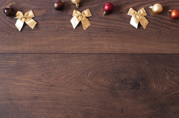 Christmas background with decorations. Christmas border design on the wooden background. Christmas theme with golden glass balls and free space for text, copy space