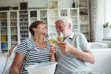 Senior couple toasting glasses of wine