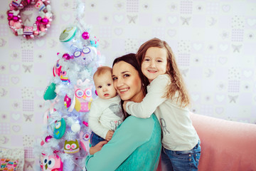 Smiling brunette mother surrounded with her little children